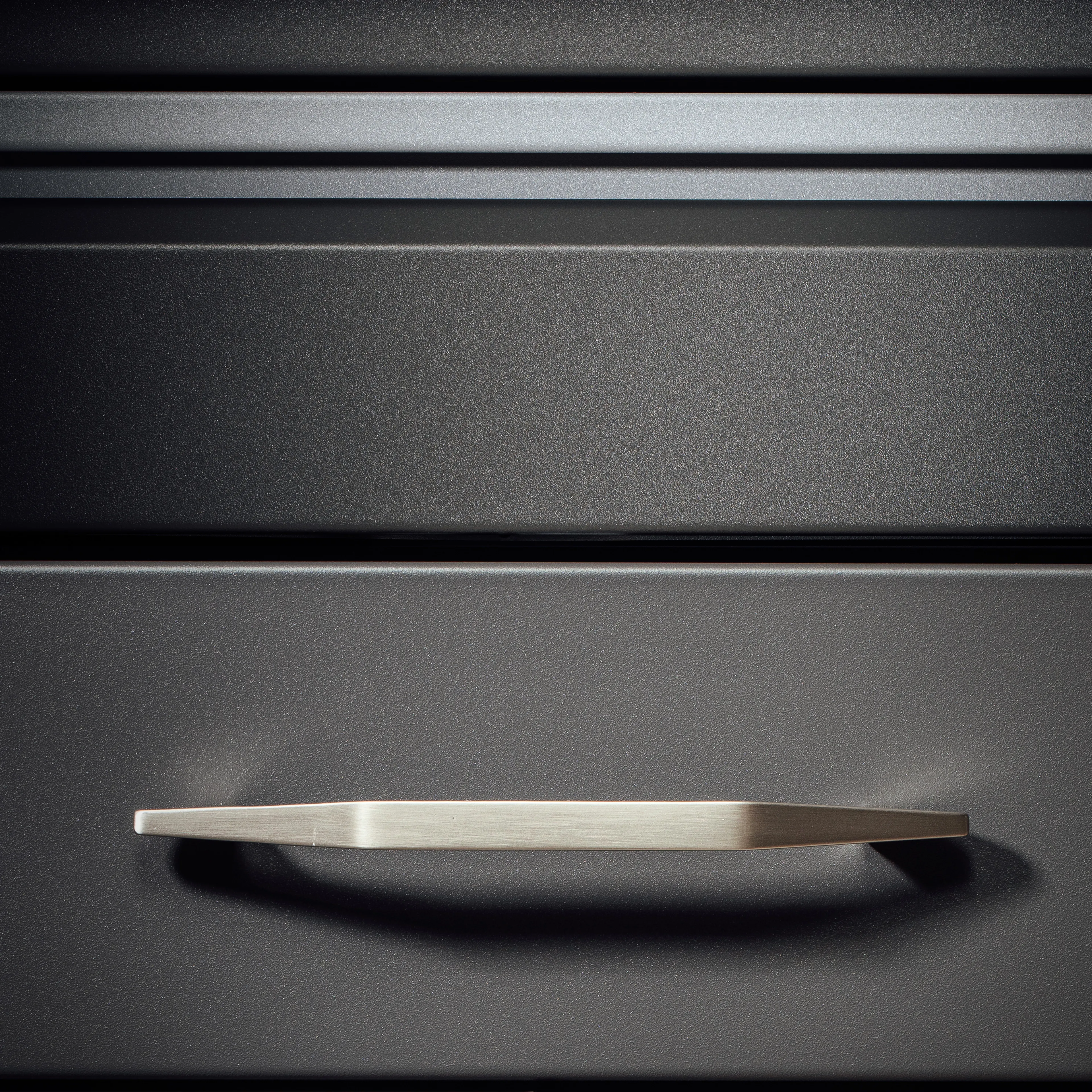 The Handle Image, showcasing a full-length handle integrated into the doors and drawers, providing a modern industrial look and unparalleled performance and longevity.
