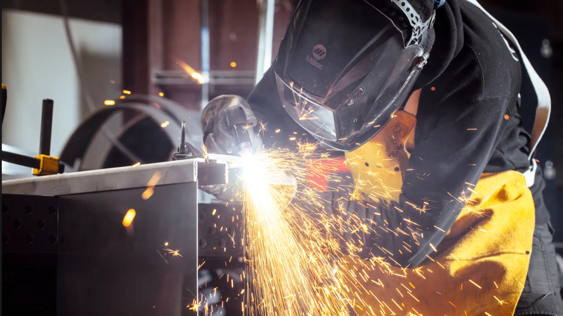 Welder at work with sparks flying at Baldhead Cabinets