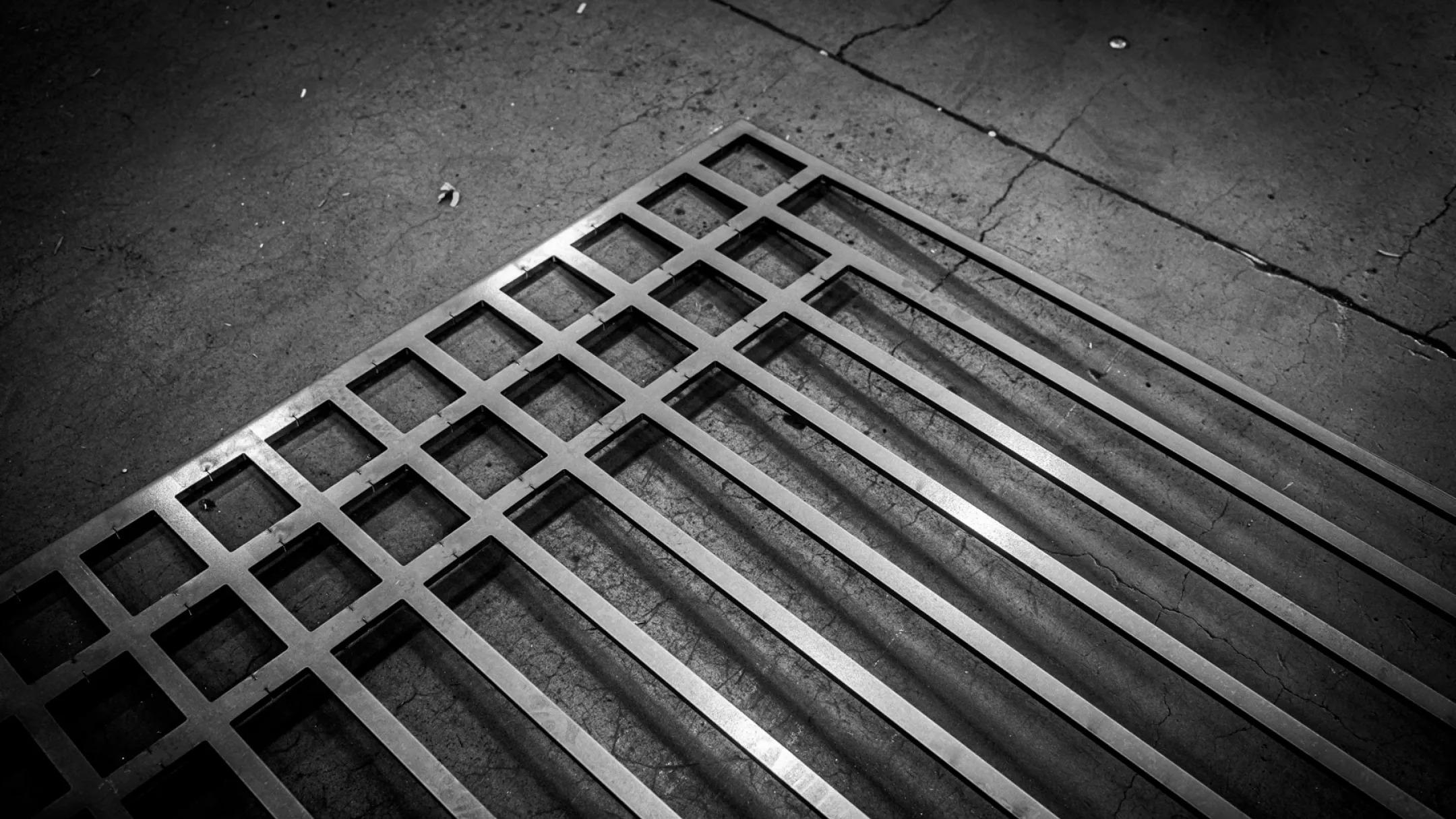 A close-up of metal grating showcases the precision in our materials at Baldhead Cabinets.