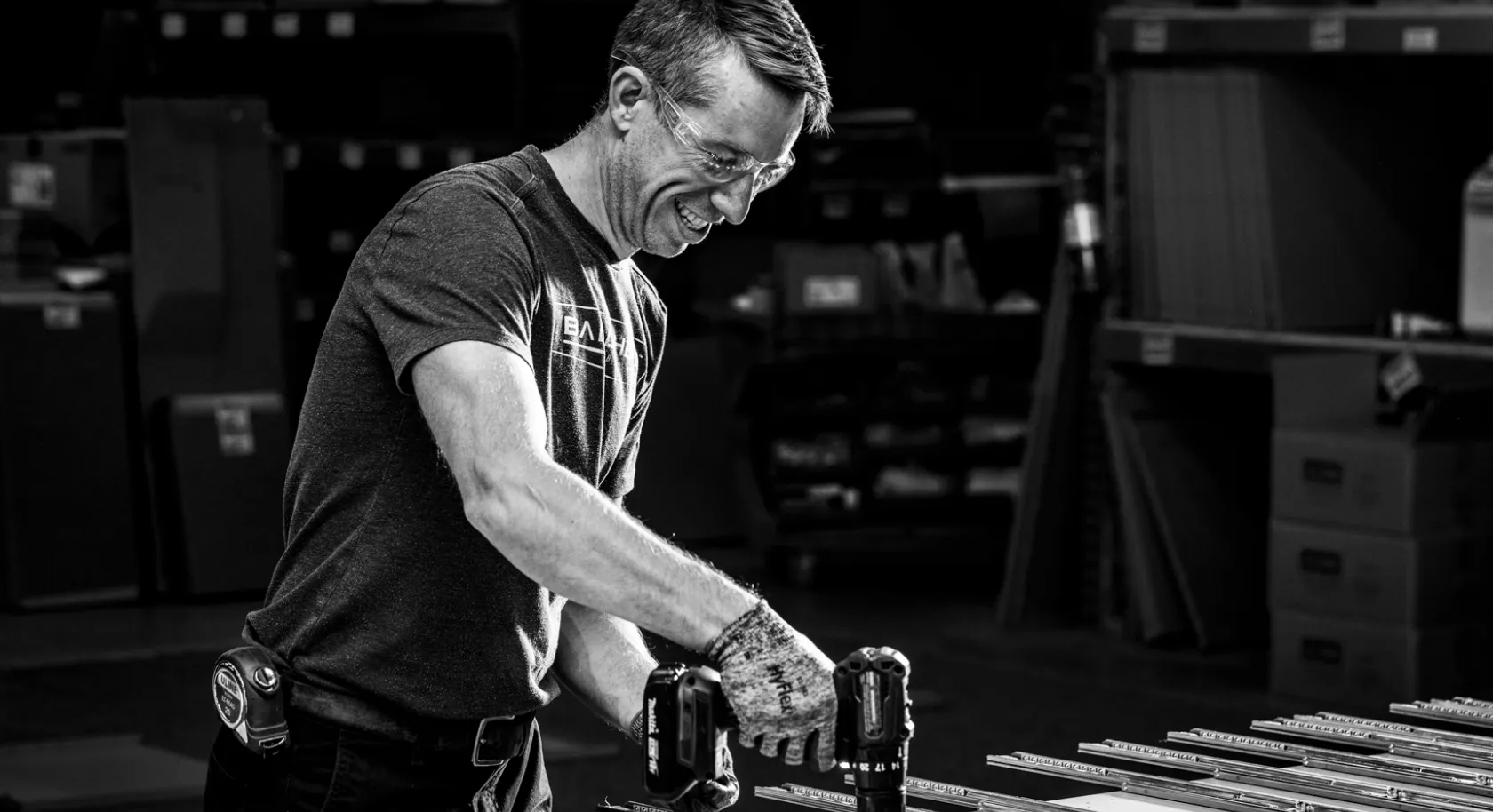 Dedicated craftsman assembling premium metal cabinets with precision tools at Baldhead Cabinets' manufacturing facility.