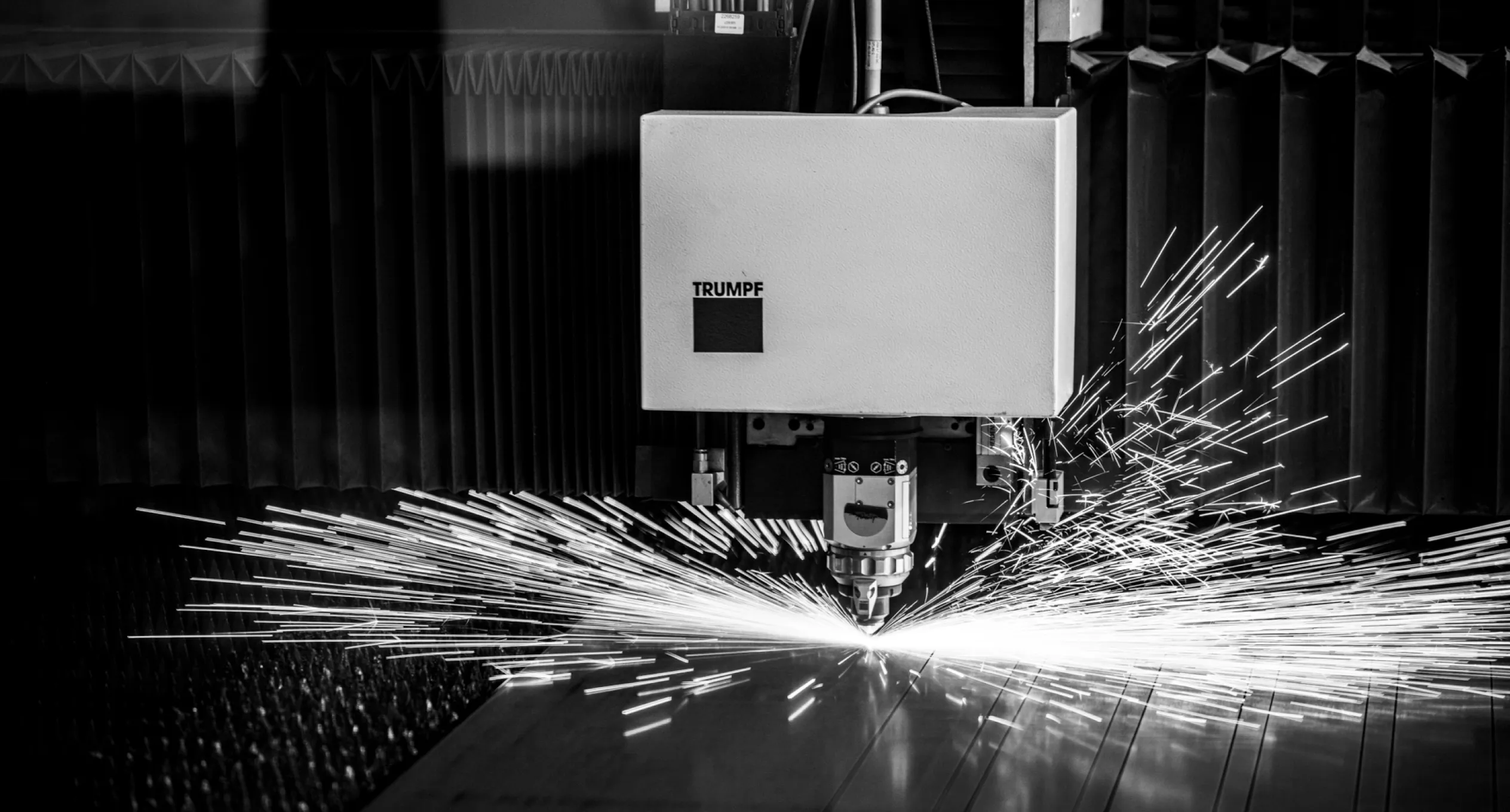 Precision laser cutting machine in action, creating custom metal components for Baldhead Cabinets' high-quality cabinetry solutions.